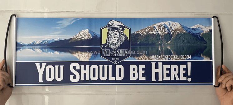 Blue custom hand banner with bold English text reading 'You Should Be Here!' for public awareness campaigns or event promotion