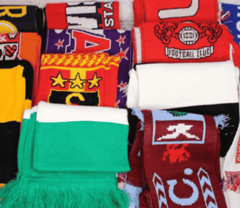 A vibrant collection of custom soccer scarves featuring various club crests and designs, perfect for fans seeking custom made soccer scarves for matchdays.