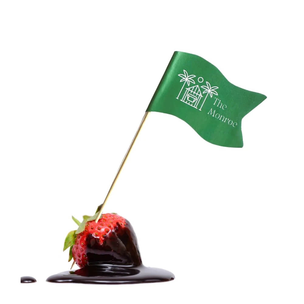 Custom toothpick flag with green flag on a red apple, demonstrating branding for food presentation.